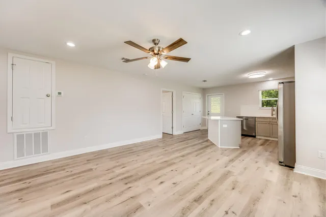 a view of a kitchen with a sink and a window