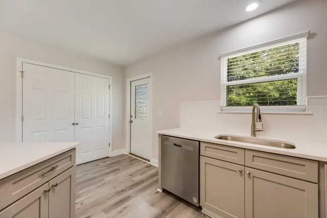 a kitchen with a sink cabinets and window