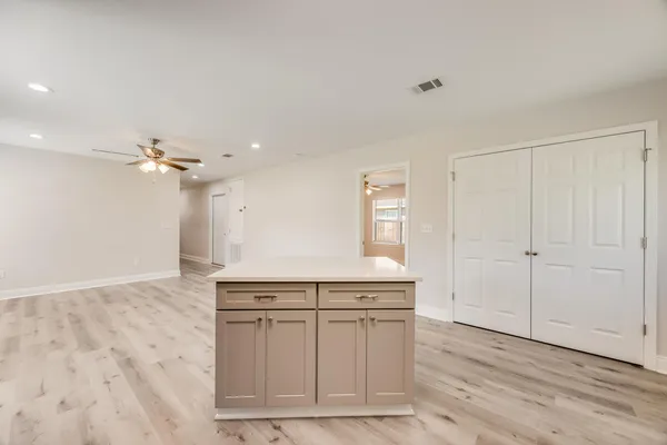 a kitchen with a sink cabinets and chandelier