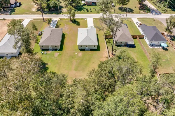 an aerial view of residential house with outdoor space and swimming pool