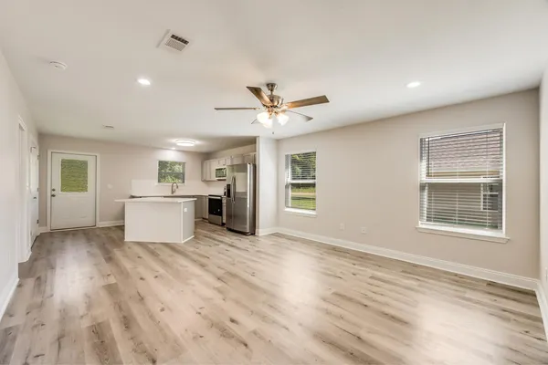 a view of a kitchen with a sink and a window