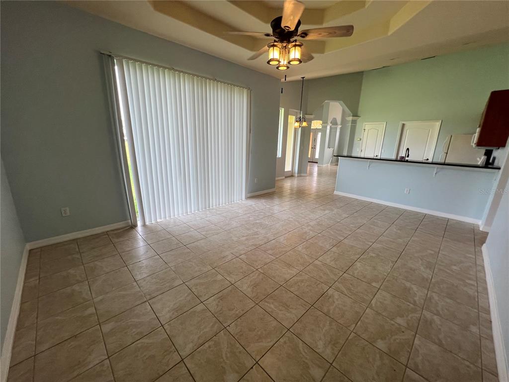 99 Flanders Street Port Charlotte, FL 33954 - Photo 11 of 29 a view of a livingroom with a chandelier furniture and windows