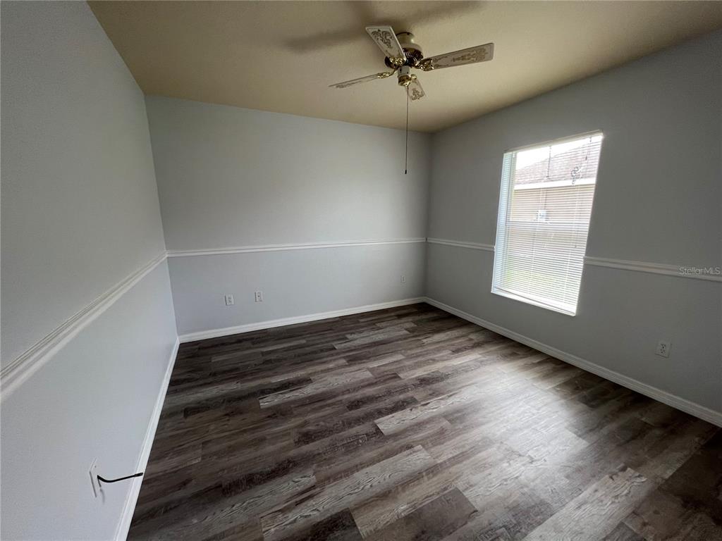 99 Flanders Street Port Charlotte, FL 33954 - Photo 13 of 29 a view of an empty room with wooden floor and a window