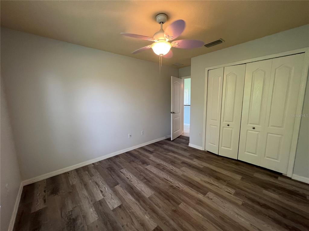 99 Flanders Street Port Charlotte, FL 33954 - Photo 17 of 29 wooden floor in an empty room