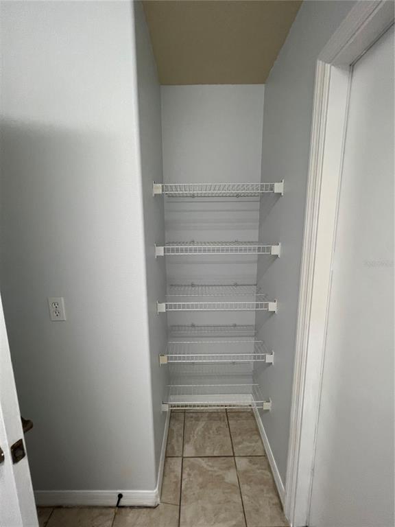 99 Flanders Street Port Charlotte, FL 33954 - Photo 19 of 29 a view of walk in closet with empty racks