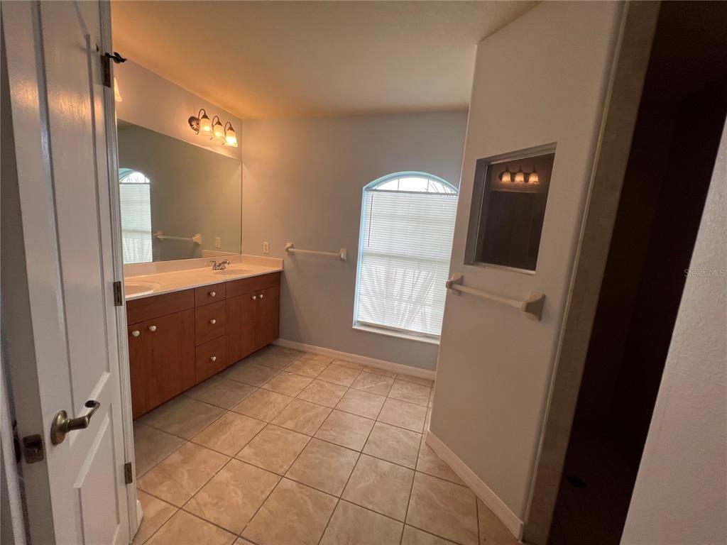 99 Flanders Street Port Charlotte, FL 33954 - Photo 24 of 29 a view of a bathroom from a hallway