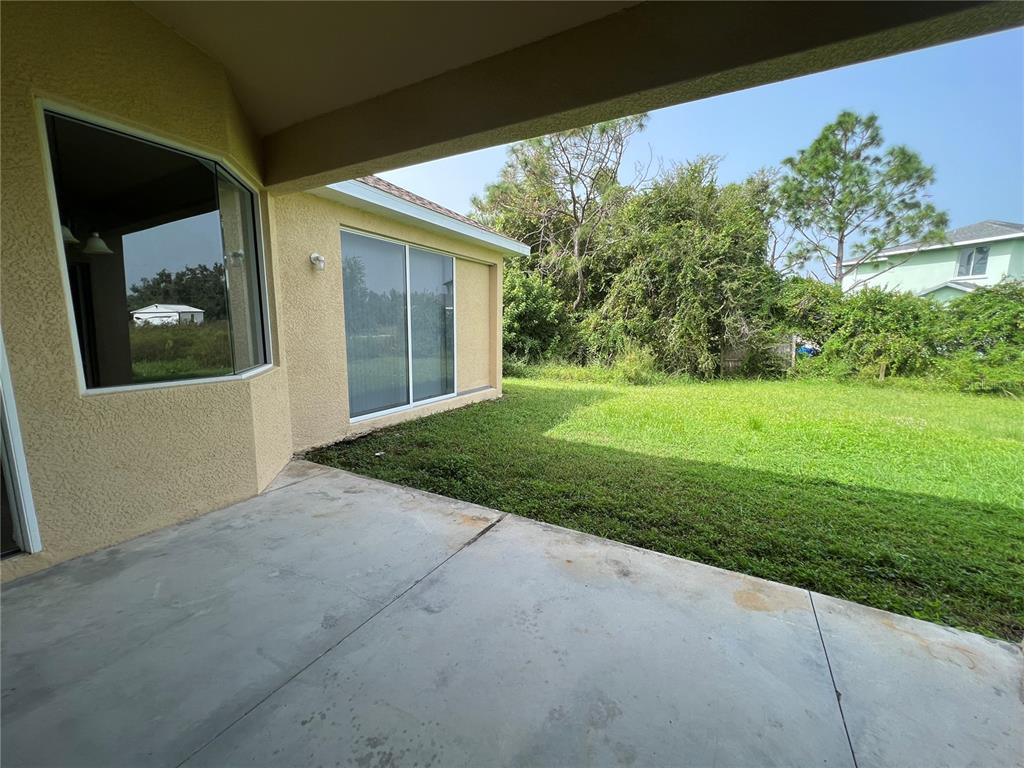 99 Flanders Street Port Charlotte, FL 33954 - Photo 27 of 29 a view of a house with a yard