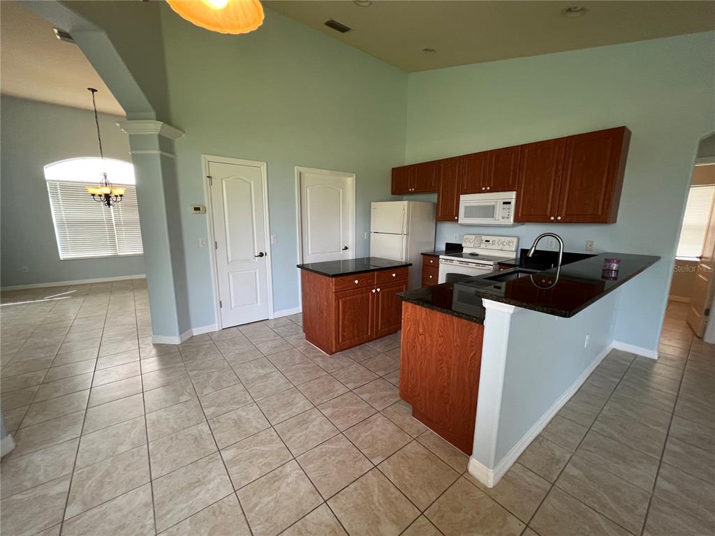99 Flanders Street Port Charlotte, FL 33954 - Photo 8 of 29 a kitchen with stainless steel appliances a stove a sink a refrigerator a window