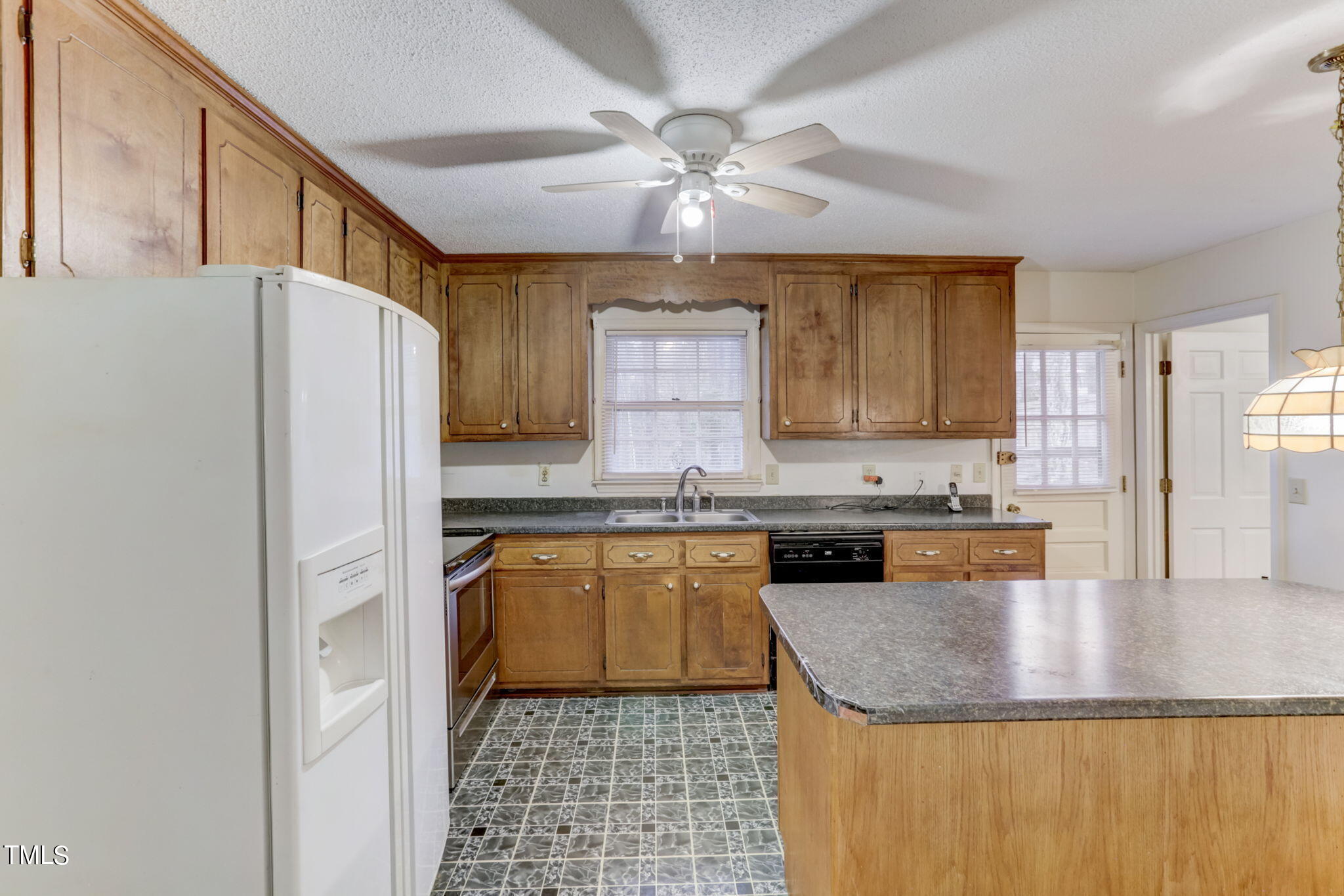 5502 Russell Road Durham, NC 27712 - Photo 8 of 31 a kitchen with granite countertop stainless steel appliances a stove a sink a refrigerator cabinets and dining table