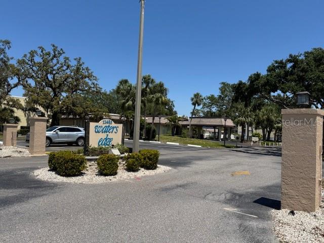 11485 Oakhurst Road, Unit 319 Largo, FL 33774 - Photo 63 of 63 a front view of a house with a yard and trees
