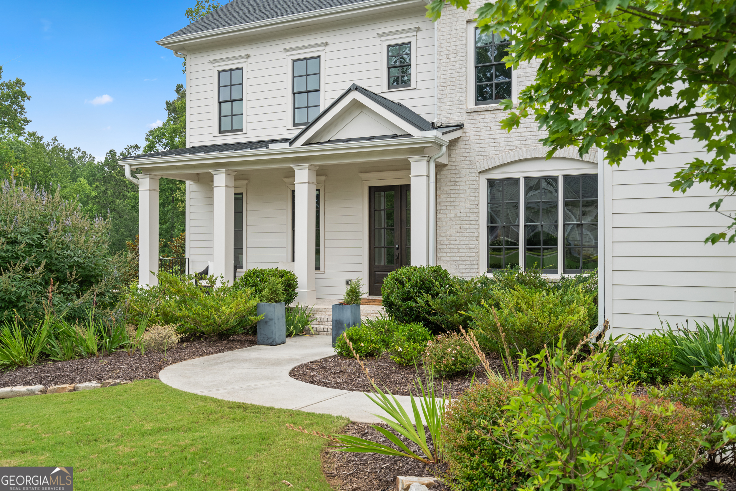 2045 Kent Court Milton, GA 30004 - Photo 12 of 104 a front view of a house with a yard and potted plants