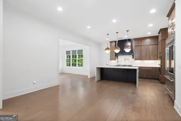 a view of wooden floor and windows in an empty room