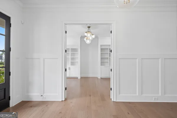 a dining room with furniture and a floor to ceiling window