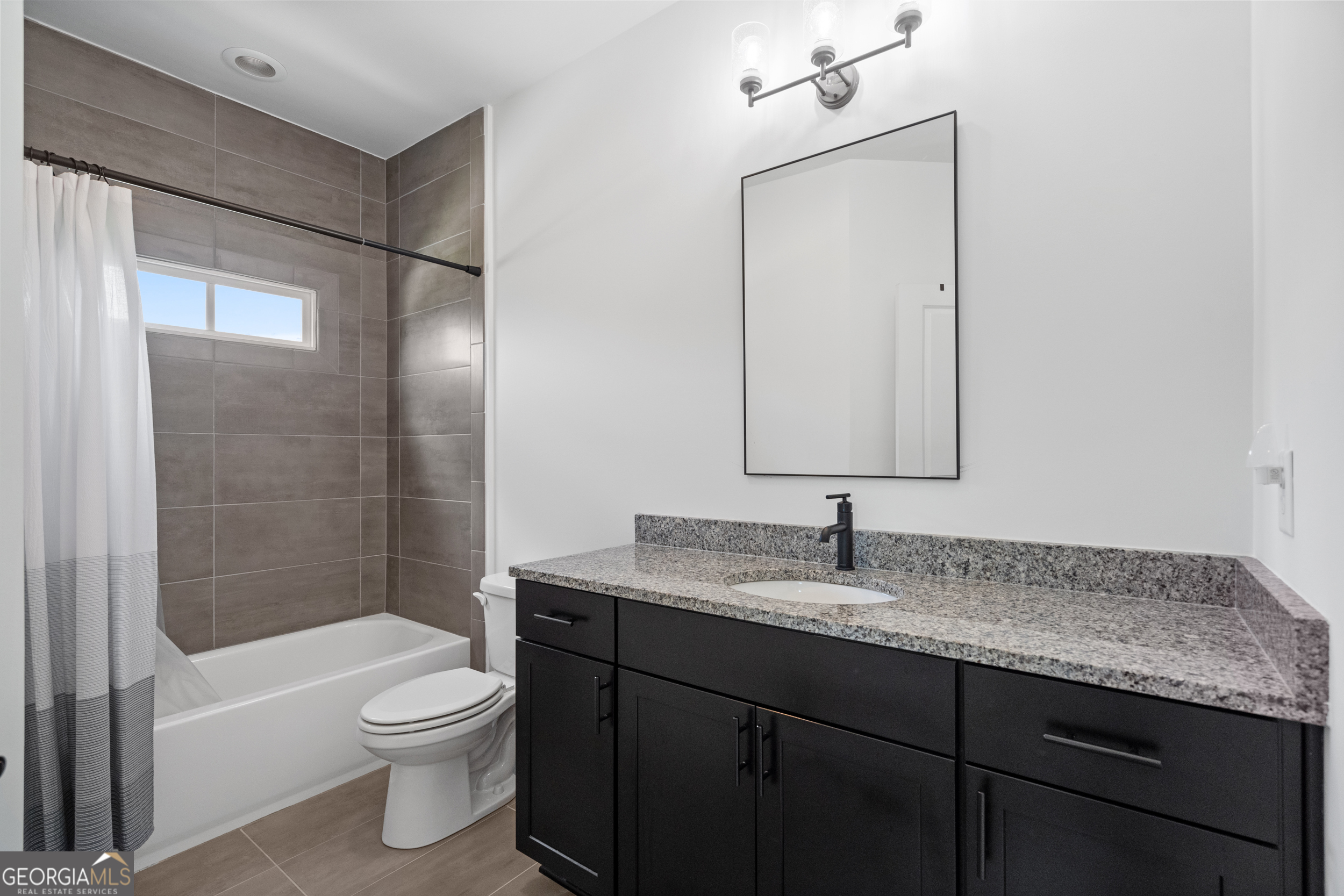 2045 Kent Court Milton, GA 30004 - Photo 65 of 104 a bathroom with a granite countertop sink toilet and shower