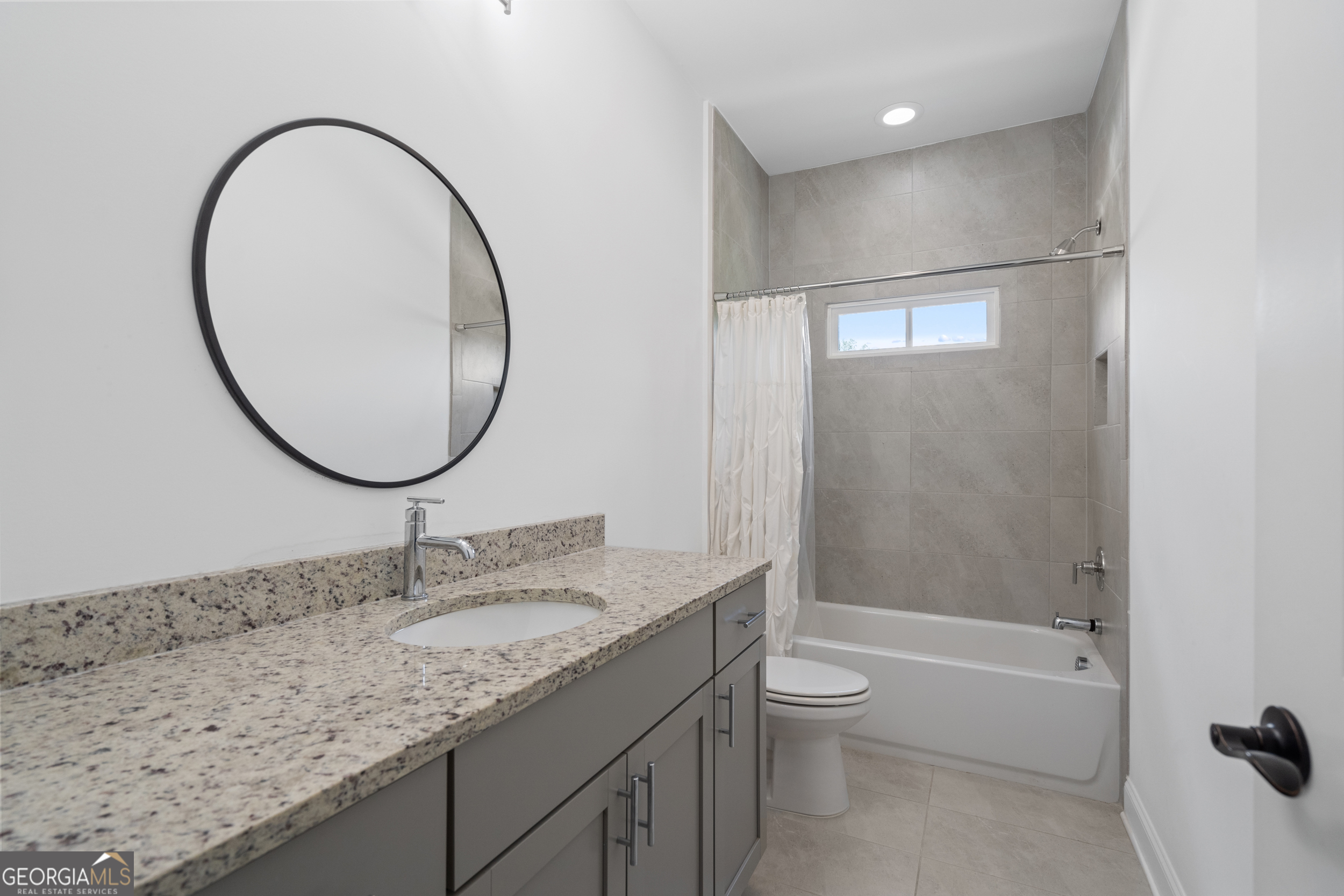 2045 Kent Court Milton, GA 30004 - Photo 67 of 104 a bathroom with a granite countertop sink a toilet and a mirror