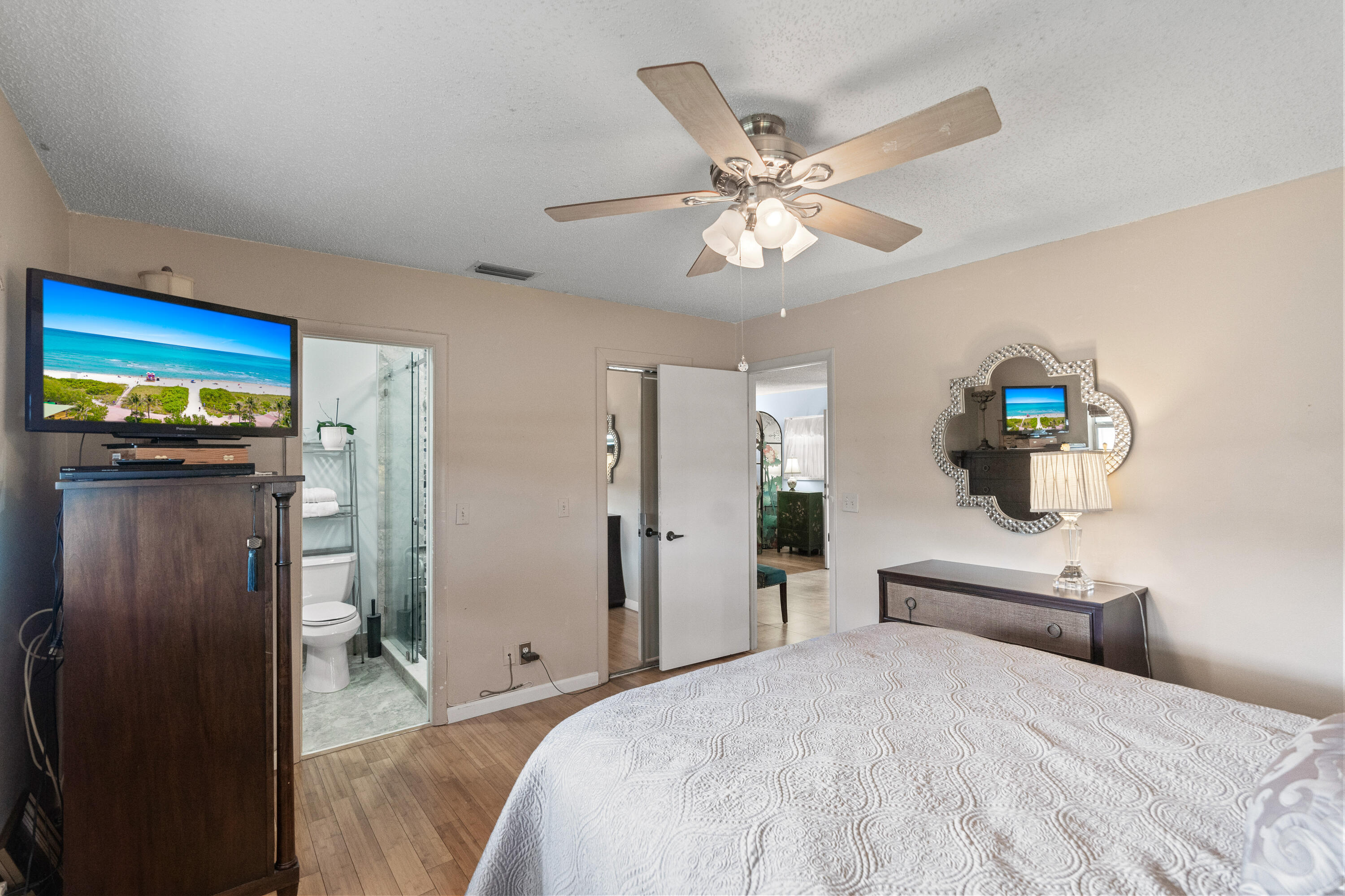 249 Cardinal Lane Delray Beach, FL 33445 - Photo 11 of 36 a bedroom with a bed and a chandelier