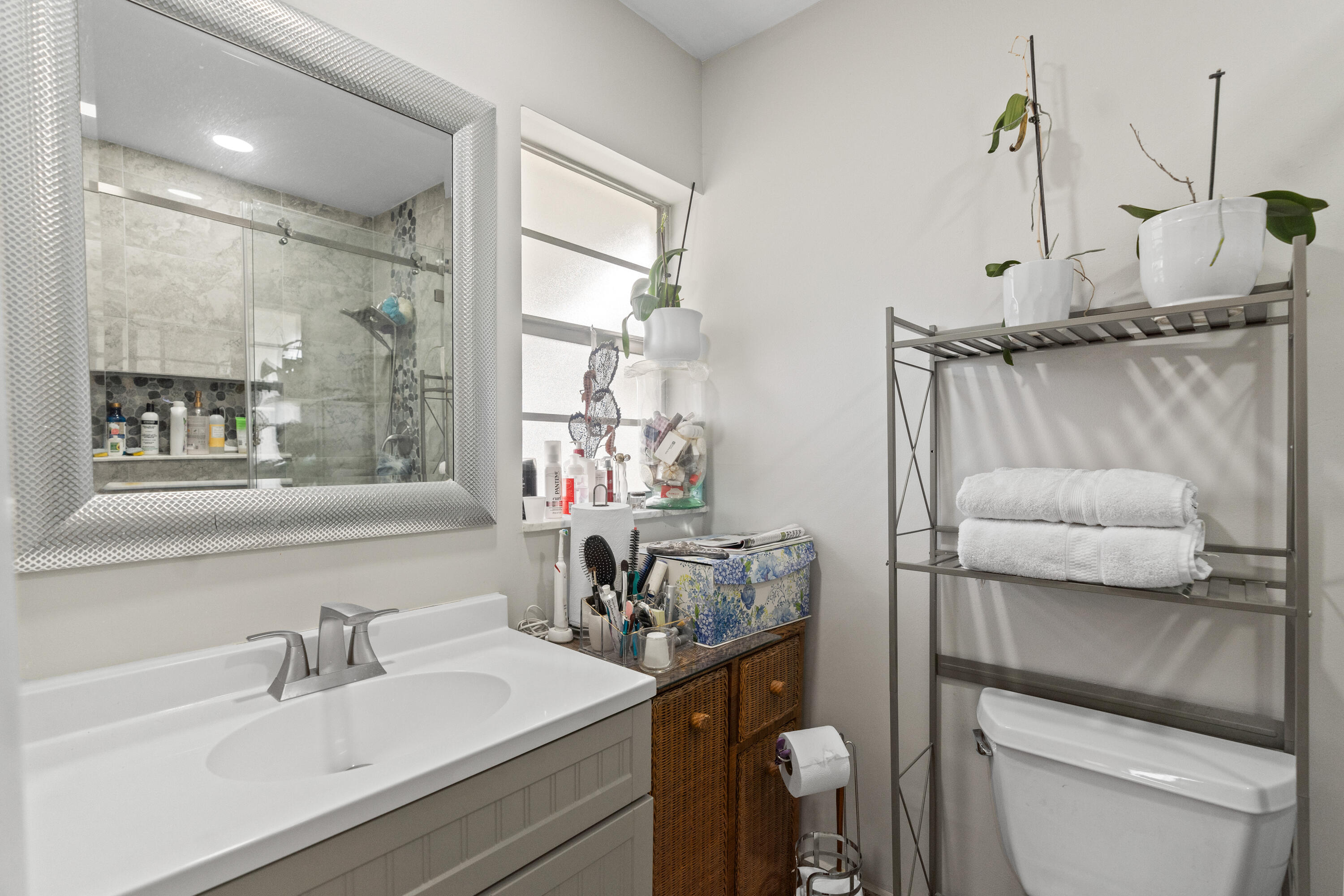 249 Cardinal Lane Delray Beach, FL 33445 - Photo 12 of 36 a bathroom with a sink a toilet and shower