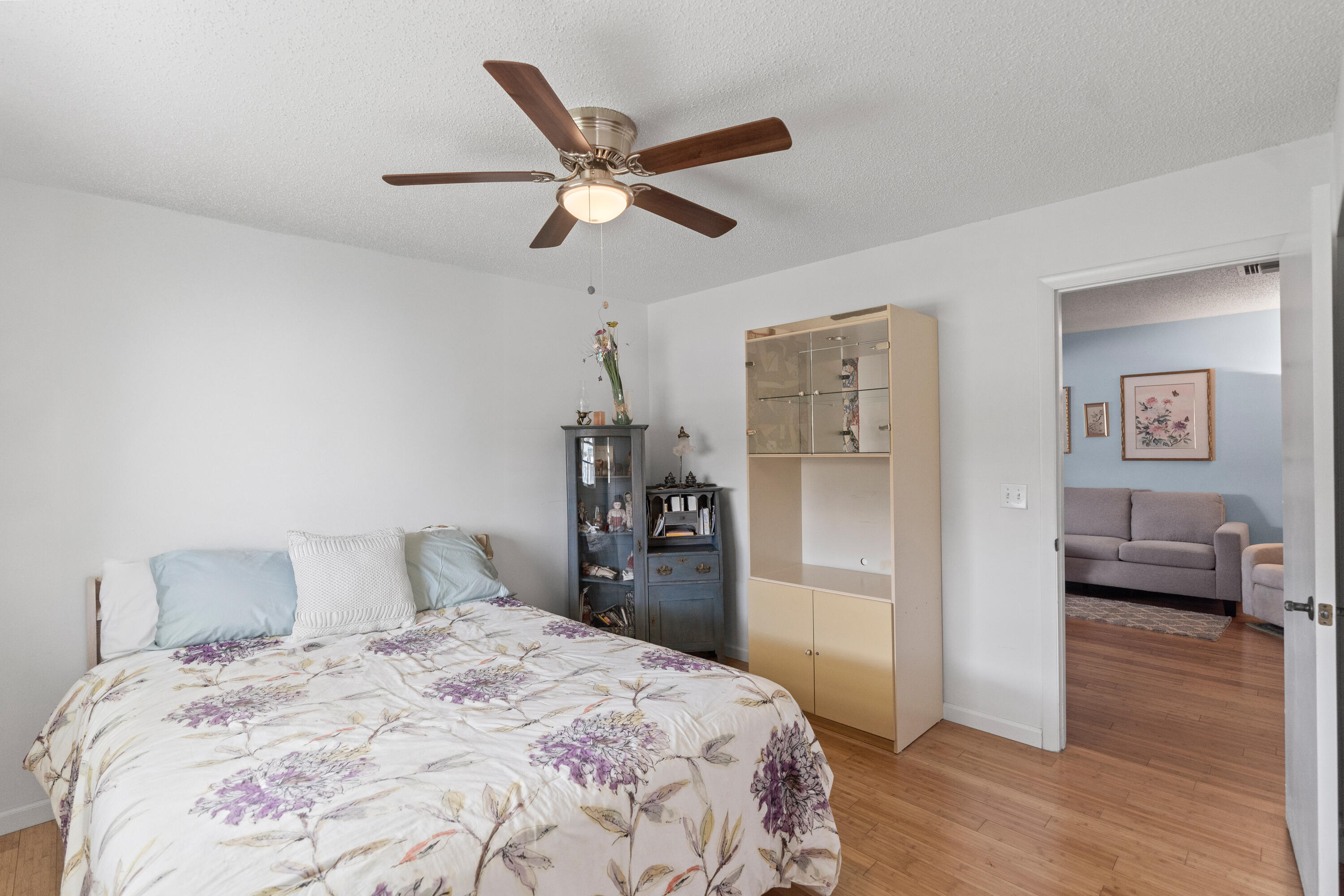 249 Cardinal Lane Delray Beach, FL 33445 - Photo 20 of 36 a bedroom with a bed and a chandelier