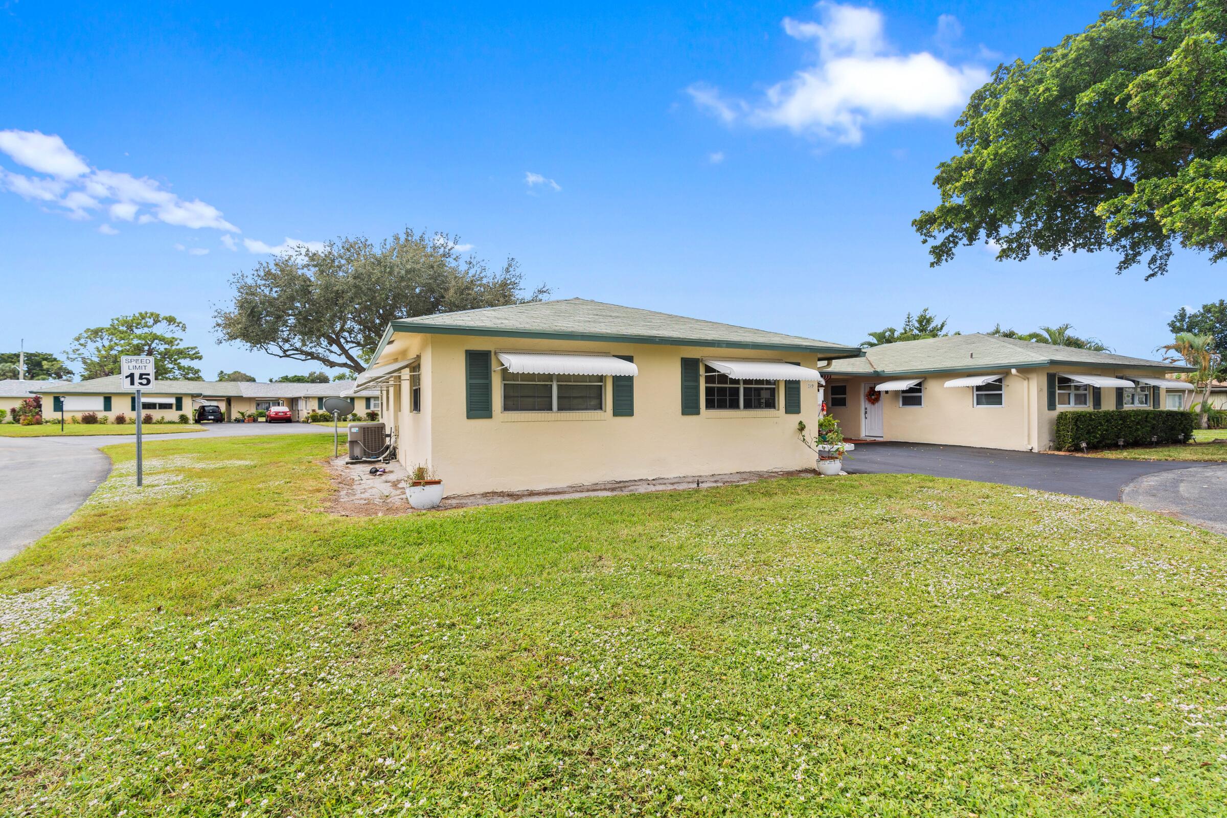 249 Cardinal Lane Delray Beach, FL 33445 - Photo 2 of 36 a view of a house with a big yard
