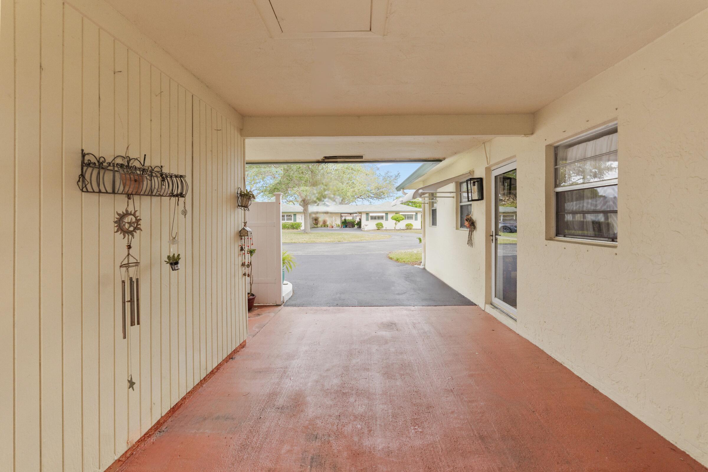 249 Cardinal Lane Delray Beach, FL 33445 - Photo 26 of 36 a view of a hallway with wooden shelves