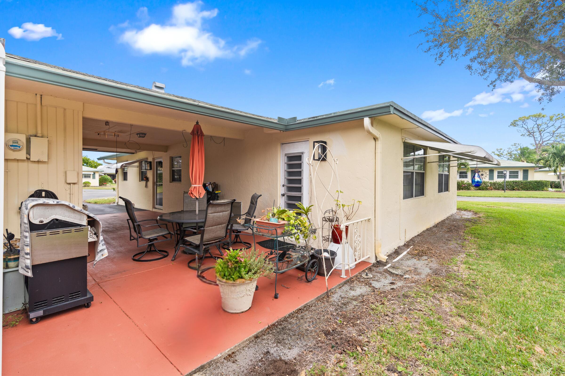 249 Cardinal Lane Delray Beach, FL 33445 - Photo 27 of 36 a view of a patio with couple of chairs and potted plants