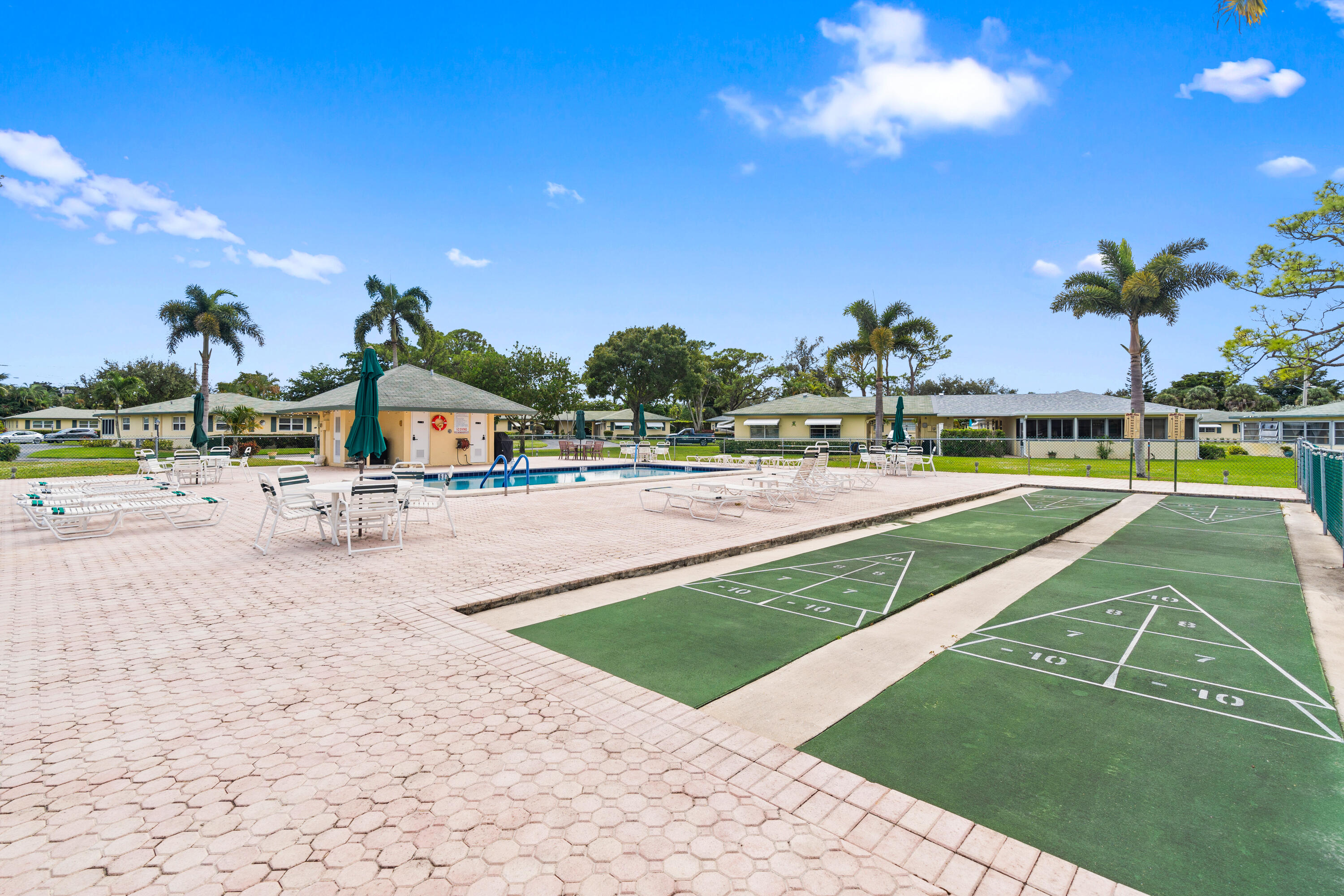 249 Cardinal Lane Delray Beach, FL 33445 - Photo 34 of 36 a view of a swimming pool and an outdoor space