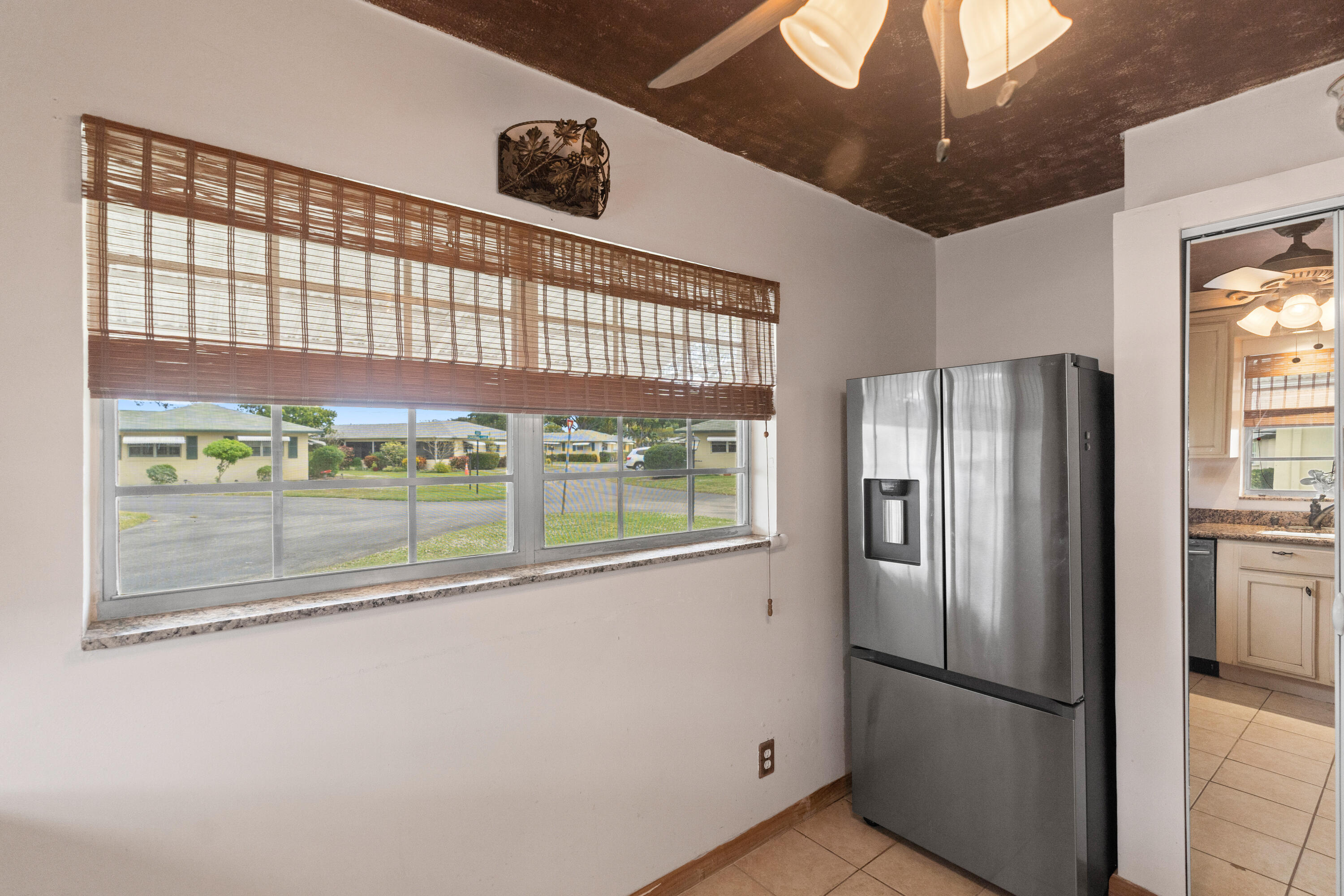 249 Cardinal Lane Delray Beach, FL 33445 - Photo 7 of 36 a kitchen with stainless steel appliances granite countertop a refrigerator and a sink