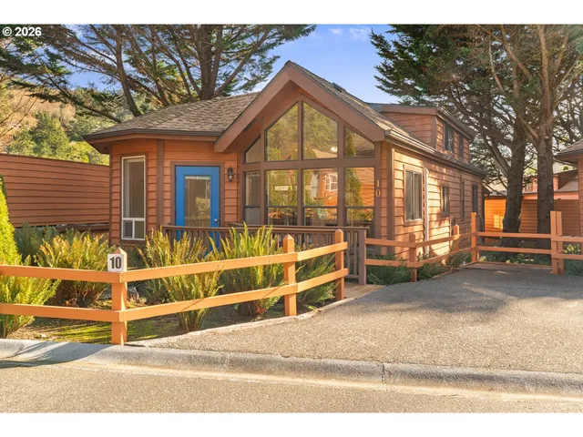 a view of a house with wooden fence