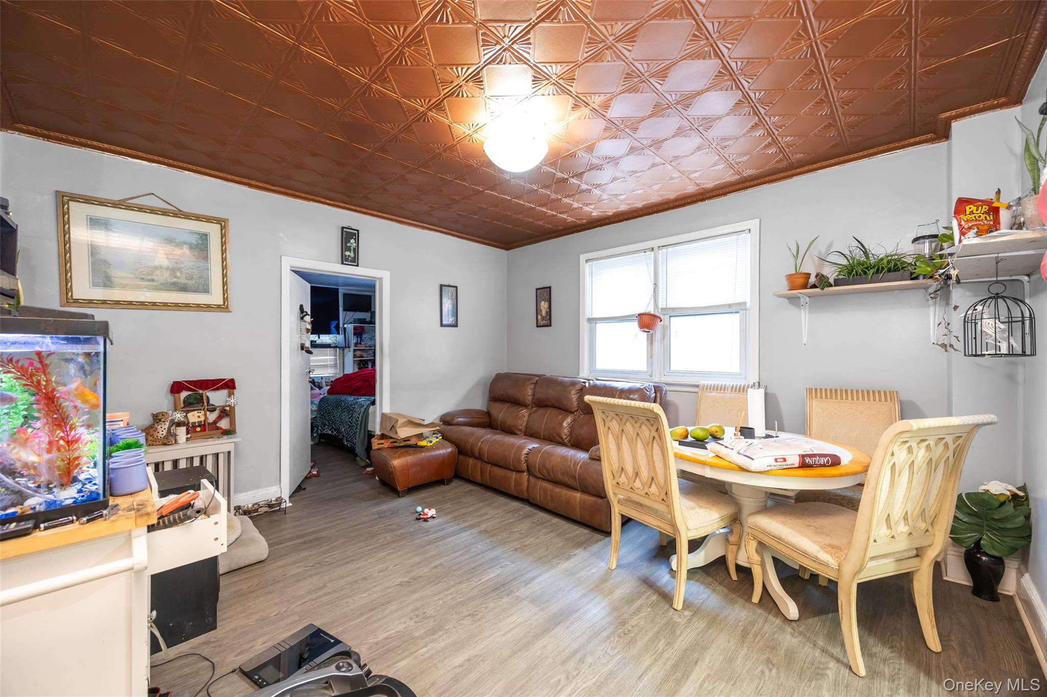 65-11 Perry Avenue Queens, NY 11378 - Photo 18 of 22 a living room with furniture and a window