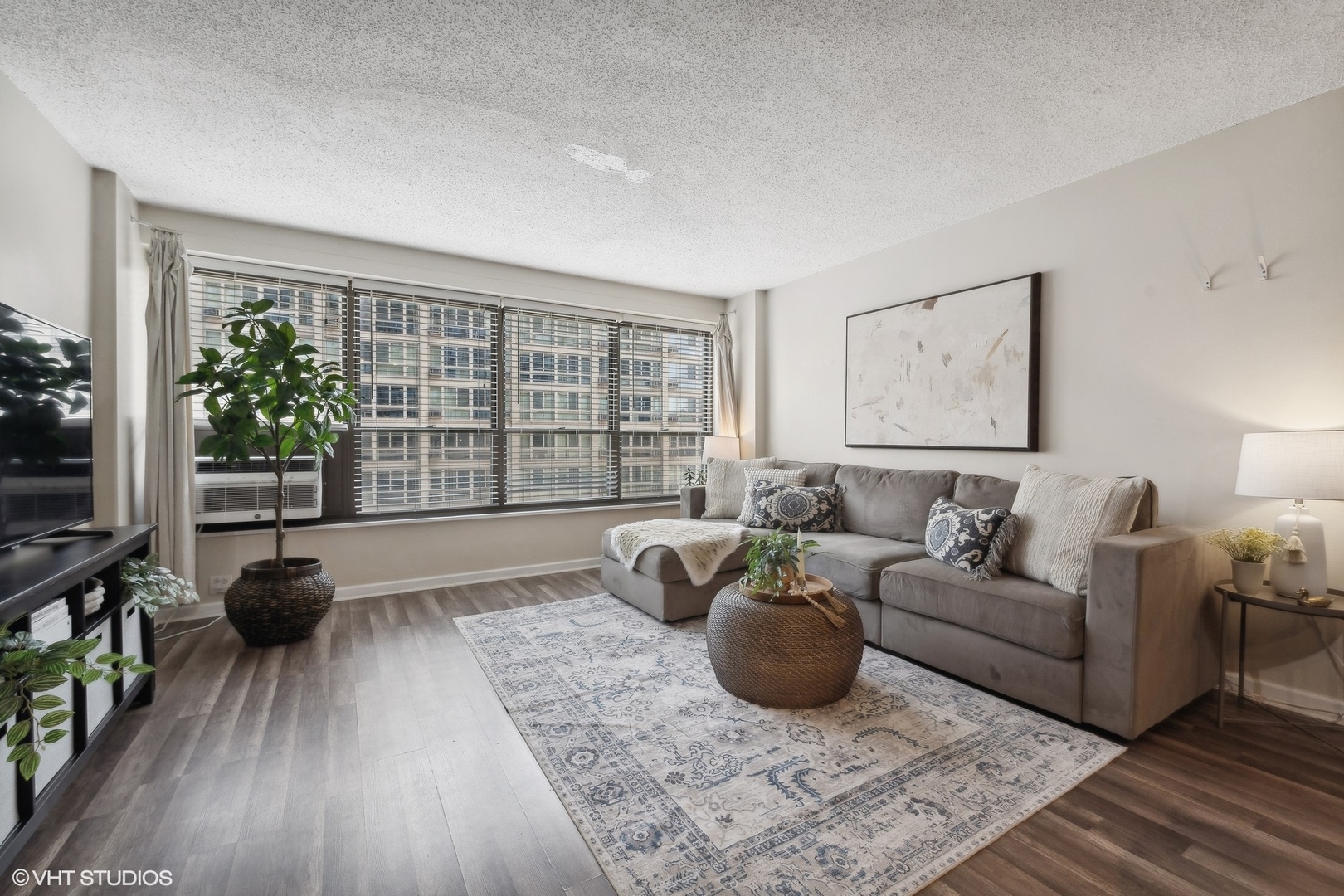 2930 North Sheridan Road, Unit 909 Chicago, IL 60657 - Photo 7 of 17 a living room with furniture and a large window