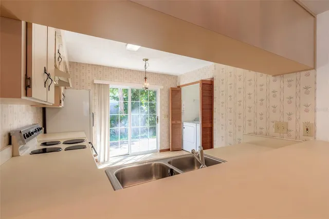 a view of a kitchen with a sink and a window
