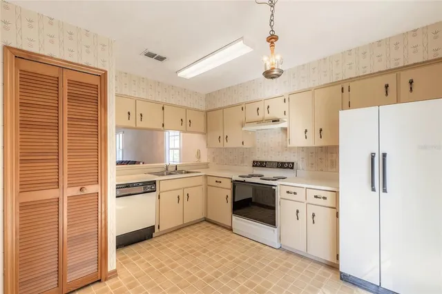a kitchen with cabinets stainless steel appliances and counter space