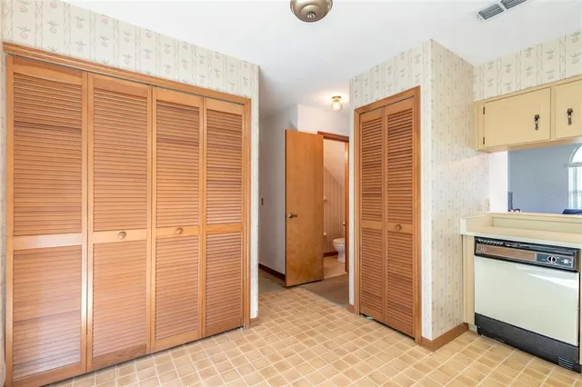 a view of kitchen with granite countertop cabinets and refrigerator