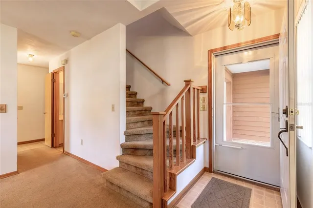 a view of entryway with wooden floor and stairs