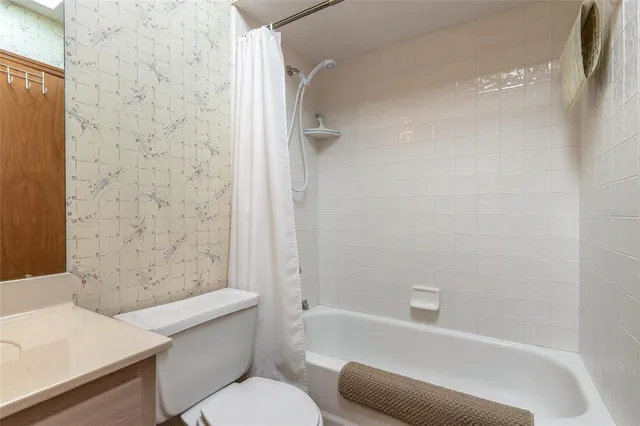 a bathroom with a toilet and a bathtub
