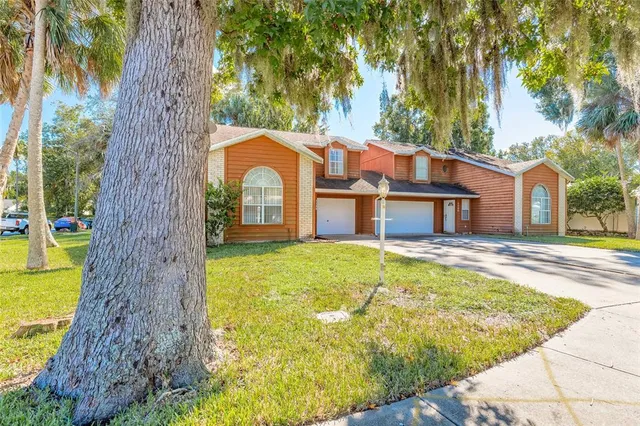 a front view of house with a garden