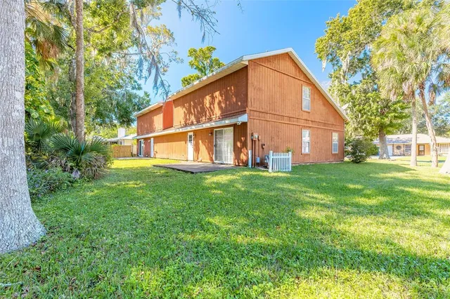 a view of house with backyard