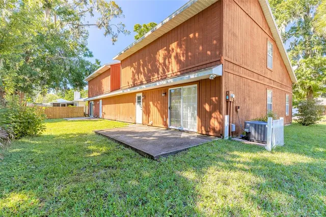 a view of a house with a yard and a patio