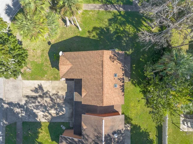 an aerial view of a house with a yard