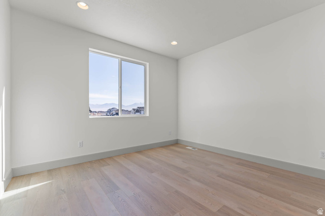 562 West Coyote Rdg Road Grantsville, UT 84029 - Photo 9 of 27 Spacious room featuring light wood-finish flooring, recessed lighting, and a large window