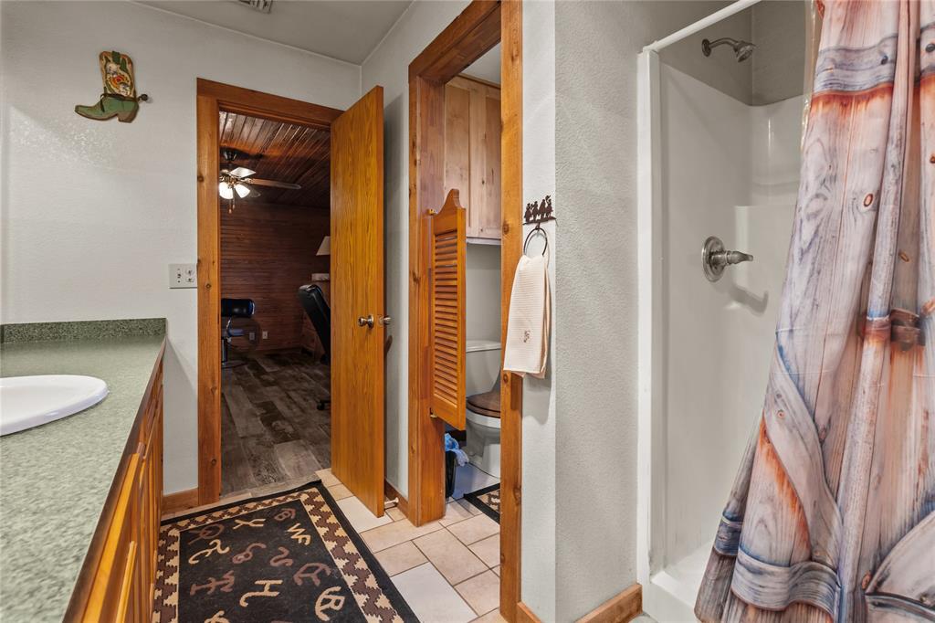 262 North Cheyenne Springtown, TX 76082 - Photo 20 of 35 Full bathroom with a stall shower, vanity, and light tile patterned floors