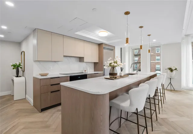 a kitchen with a table chairs stove and white cabinets