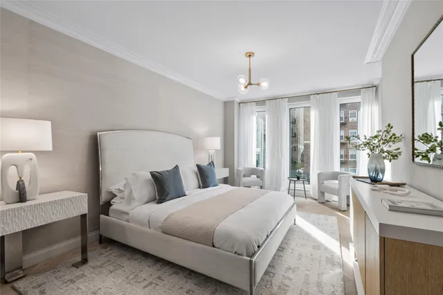 a bedroom with a large bed and a chandelier