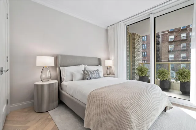 a bedroom with a large bed and a large window