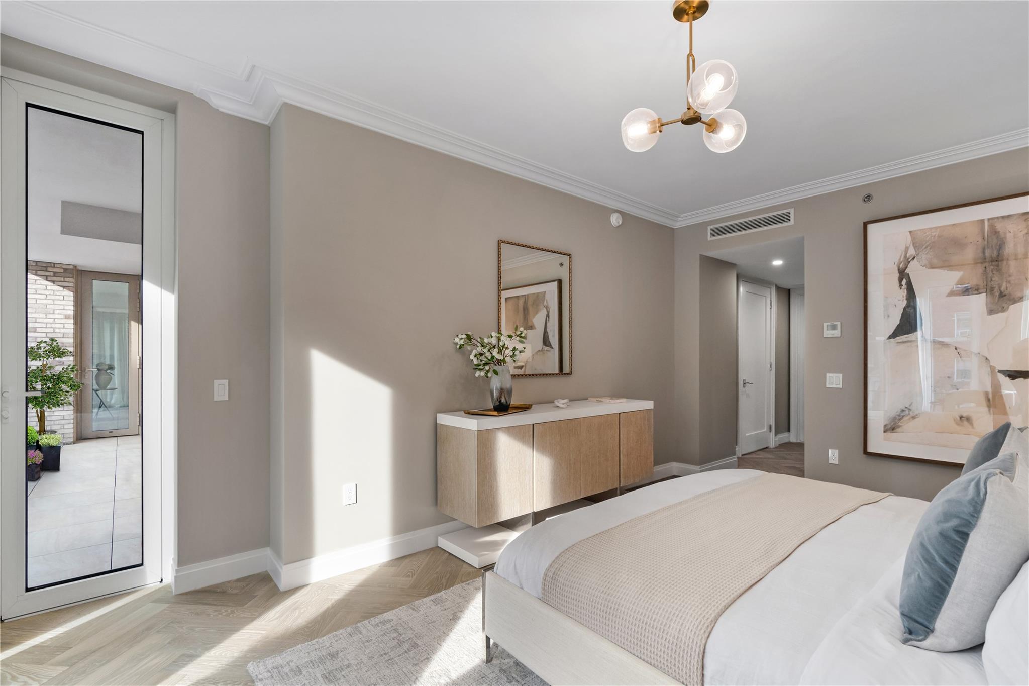 78-29 Austin Street, Unit PH1C Queens, NY 11375 - Photo 9 of 27 a bedroom with a bed and a chandelier