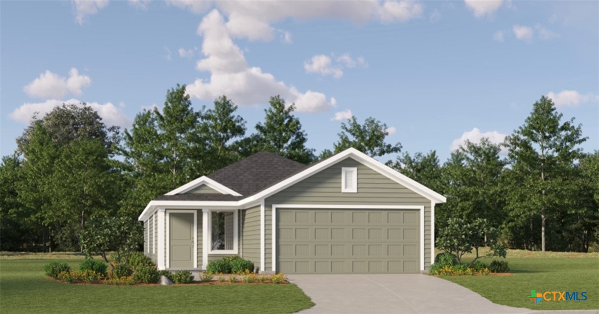 a front view of a house with a yard and trees