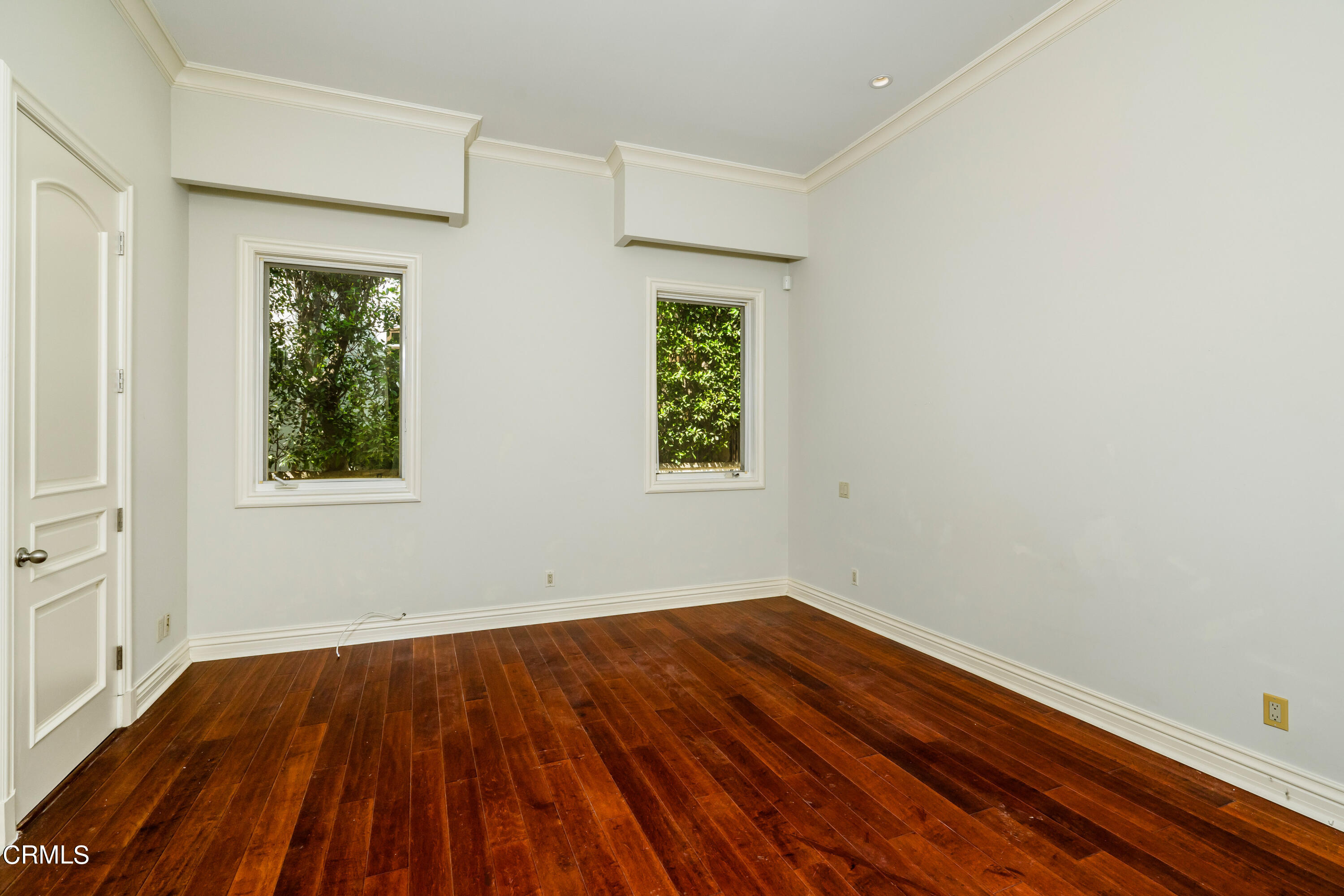 1165 Arden Road Pasadena, CA 91106 - Photo 14 of 25 an empty room with wooden floor and windows