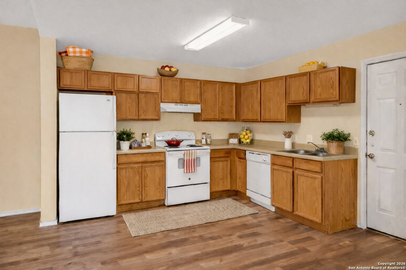 3812 Maverick Crk Road San Antonio, TX 78247 - Photo 6 of 24 a kitchen with white cabinets and white appliances