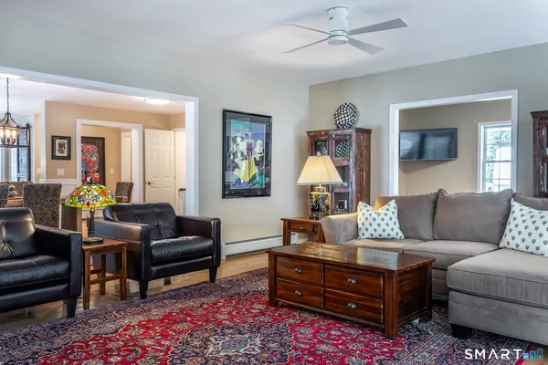 a living room with furniture a rug and a chandelier