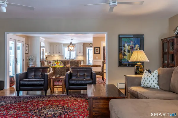 a living room with furniture and a lamp
